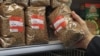 Russia - A shopper holds a buckwheat packet at a Moscow supermarker, March 20, 2020.