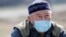 Kazakhstan - A man wearing a protective mask is seen near a check point, following the Kazakh state emergency commission's decision to lock down Almaty to prevent the spread of coronavirus disease (COVID-19), on the outskirts of Almaty, Kazakhstan March 1