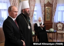 Президент Росії Володимир Путін (ліворуч) під час вручення державної нагороди Росії керуючому справами Української православної церкви (Московського патріархату), митрополиту Бориспільському Антонію (в центрі). Праворуч – патріарх Московський Кирило. Київ, 27 липня 2013 року