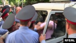 Armenia -- An opposition supporter is forced into a police vehicle near Yerevan's Liberty Square, 31May 2010.