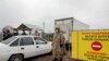 KAZAKHSTAN -- Police officers wearing a protective gear are seen at a checkpoint set up to lock down the city to prevent the spread of the COVID-19 coronavirus disease, on the outskirts of Almaty, March 23, 2020