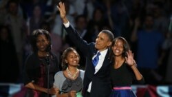 U.S. -- President Barack Obama walks on stage with first lady Michelle Obama and daughters Sasha and Malia to deliver his victory speech on election night in Chicago, 07Nov2012