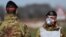 Italian Army soldiers wearing protective masks check transit to and from the cordoned areas in a check-point few kilometers from the small town of Castiglione d'Adda, southeast of Milan, on February 27, 2020 amid fears over the spread of the novel Coronav