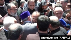 Armenia - Catholicos Garegin II hugs Archbishop Mikael Ajapahian during a standoff with security forces at the Echmiadzin headquarters of the Armenian Apostolic Church, June 27, 2025.