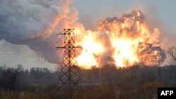 A ball of fire is seen following an explosion on the outskirts of the eastern city of Donetsk on October 20. Human Rights Watch cited "particularly strong evidence" that Ukrainian military forces had used cluster munitions on several occasion in Donetsk, a rebel stronghold with a prewar population of around 1 million people.