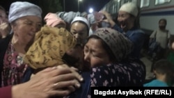 Family members greet new arrivals at the train station in Zhanaozen in Kazakhstan’s Manghystau region on May 13.