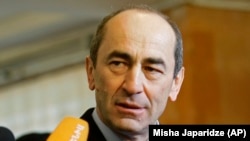 ARMENIA -- Then Armenian President Robert Kocharian talks to the media at a polling station in Yerevan, February 19, 2008