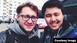 Руслан Токочев жолдо тапкан жаңы таанышы Антон менен Үрүмчү шарында. Кытай, апрель, 2014.