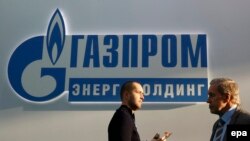 Russia -- Participants walk in front of the logo of Russian gas company Gazprom, during the ENES 2016 Energy Efficiency and Energy Development Forum & Exhibition in Moscow, November 23, 2016