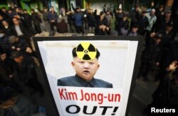 South Korea -- Anti North Korea civic group hold signs and chant slogans during a rally denouncing North Korea's possible nuclear test plan, in Seoul, 31Jan2013