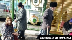 Пожилые люди на автобусной остановке в Туркменистане