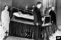 North Vietnamese leaders stand around the body of President Ho Chi Minh on September 7, 1969.