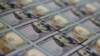 U.S. - Newly redesigned $100 notes lay in stacks at the Bureau of Engraving and Printing in Washington, DC, May 20, 2013.