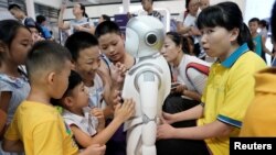 Дүйнөлүк робот конференциясында балдар робот менен ойноодо. Бээжин, 17-август, 2018-жыл.