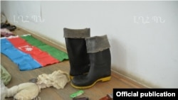 Nagorno-Karabakh - Weapons, ammunition and an Azerbaijani flag which the Karabakh Armenian military says were confiscated from an arrested member of an Azerbaijani "sabotage" group, 10Jul2014.