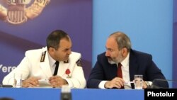 Armenia -- Prime Minister Nikol Pashinian (R) and Prosecutor-General Artur Davtian attend a festive event in Yerevan, July 1, 2019.