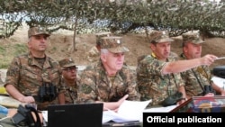 Nagorno Karabakh - Karen Abrahamian (L), Levon Mnatsakanian (second from left), and Jalal Harutiunian (second from right) watch a military exercise in August 2018.