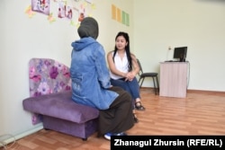 A Kazakh woman repatriated from Syria speaks to a psychologist at an Aqtobe rehabilitation center.