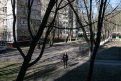 Валерыя. На заднем плане дом, адкуль яны была вымушаная зьехаць