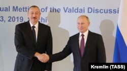 RUSSIA -- Russian President Vladimir Putin shakes hands with Azerbaijani President Ilham Aliyev during their meeting in Sochi, October 3, 2019