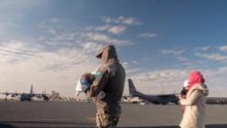 Военный и вывезенные из Сирии в рамках операции спецслужб казахстанцы.