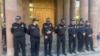 Armenia - Police officers guard the entrance to an Investigative Committee building in Yerevan where a number of priests were taken for questioning, October 15, 2025.