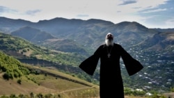 Armenia -- Priest Ter Abel prays for peace outside the village of Movses on the Armenian-Azerbaijani border, July 15, 2020