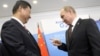 Analysts say Russian President Vladimir Putin (right) is hoping to ensure that his Chinese counterpart Xi Jinping remains a crucial ally. (file photo)
