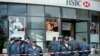 Armenian police officers stand guard after a fatal shooting incident at a branch of HSBC Bank in Yerevan on May 3. 