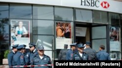 Armenian police officers stand guard after a fatal shooting incident at a branch of HSBC Bank in Yerevan on May 3. 