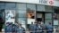 Armenian police officers stand guard after a fatal shooting incident at a branch of HSBC Bank in Yerevan on May 3. 