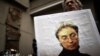 A man holds a portrait of slain Russian journalist Anna Politkovskaya during a rally marking the eighth anniversary of her death in Moscow on October 7, 2014.
