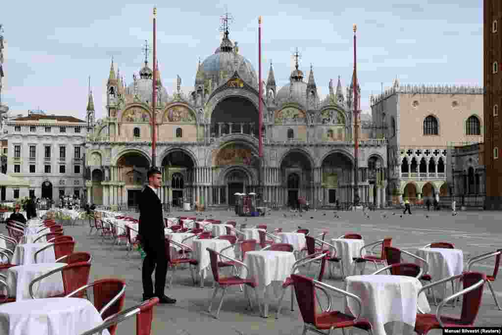 В Італії заборонені всі масові заходи, закриваються школи, університети, скасований&nbsp; національний футбольний чемпіонат. Фото: офіціант ресторану стоїть на пустій центральній площі Сан-Марко у Венеції