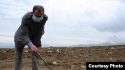 Armenia -- Journalist EdiK Baghdasaryan investigates the chemical waste disposal site in Nubarashen, Yerevan, undated