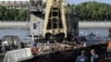 Russia -- Emergency workers look at the wreckage of the private boat "Swallow" after it was lifted from the bottom of the Moscow river in Moscow, 31Jul2011