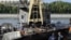 Russia -- Emergency workers look at the wreckage of the private boat "Swallow" after it was lifted from the bottom of the Moscow river in Moscow, 31Jul2011