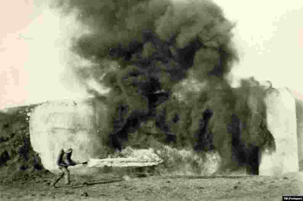 A Hungarian soldier torches a bunker on an abandoned defensive line between Romania and Hungary in 1940.