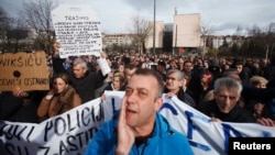 Antigovernment protesters rally in front of a government building in Sarajevo on February 10.