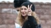 Maria Alyokhina flashes a V-sign as she arrives to attend a court hearing in Moscow in March.