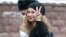 Maria Alyokhina flashes a V-sign as she arrives to attend a court hearing in Moscow in March.