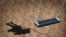 Generic - Photo ©Shutterstock. Missing child concept with an empty playground swing and the shadow of a little girl on the park floor as a symbol of children losing their childhood as being lost in a failed adoption or despair, undated