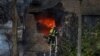 A firefighter works to put out a fire at a residential building hit by a Russian missile strike in Kyiv on November 15.