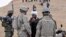 A local Afghan man from Baghdis Province talks through an interpreter (right) to a U.S. Army officer in 2011.