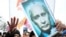 A protester holds up a picture of Vladimir Putin with the "No!" across it. As one observer notes, if the rallies are really about Putin's return to the presidency, they will only grow.
