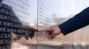 A Kosovar Albanian man points at a memorial wall as he views the names of "martyrs" in the village of Marina. (file photo)