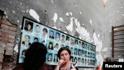 People mourn inside School Number One during a ceremony commemorating the victims of the 2004 hostage crisis in the southern Russian town of Beslan, September 1, 2014.