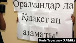 Плакат  с  обращением  к  Тимуру  Кулибаеву на казахском языке  "Оралманы  -  тоже  граждане Казахстана!".  Алматы, 4 октября 2011 года.