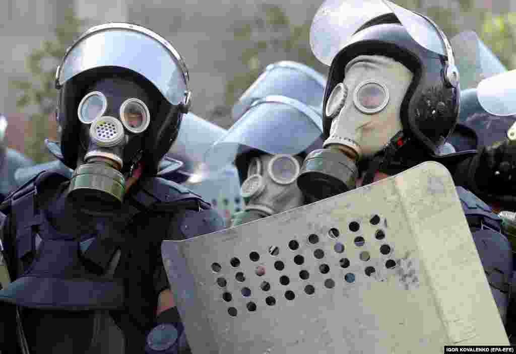 Police in gas masks during the August 8 operation. After an initial attempt to seize the former president ended on August 7 in the death of a member of the special forces and dozens of people injured, Kyrgyz authorities mustered an overwhelming police force for a second raid on the compound.&nbsp;