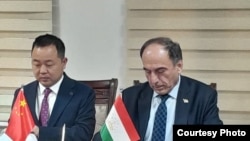 Тажикстандын транспорт министри Азим Иброхим менен Zhejiang Communications Construction Group Co. Ltd компаниясынын өкүлү Ли Минкун авто көпүрө куруу боюнча долбоорго кол коюп жатышат. 24-февраль, 2025-жыл.