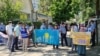 Protesters demand the return of their relatives from China outside the consulate in Almaty on May 18. 